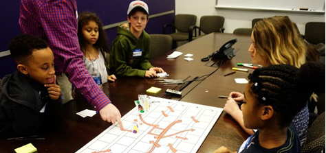 Children learning in a conference room.