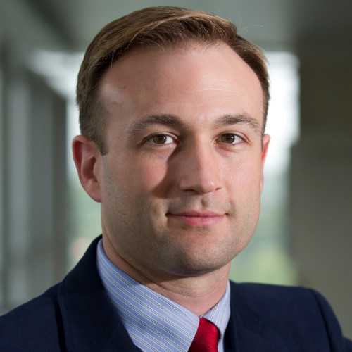 Justin Blackburn smiles in his headshot.