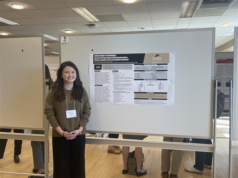 Mun Sun (Julia) Choi smiles in front of her poster presentation at the Indiana Nutrition for Health Research Showcase.