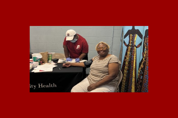 A woman has her blood pressure taken.